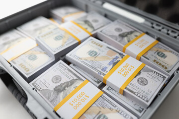 Close-up of briefcase full of stacks of dollar bills. Metal suitcase full of money. © megaflopp