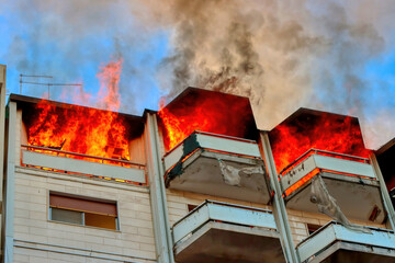 Fire in an attic of a building in an Italian city. Apartment on fire and flames
