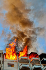 Fire in an attic of a building in an Italian city. Apartment on fire and flames