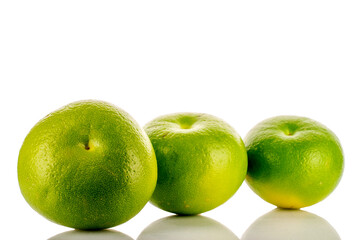 Three organic juicy Citrus Sweetie, close-up, on a white background.