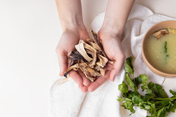 Man holds dried mushrooms. Wild mushroom soup