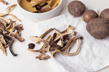 Dried mushrooms and potatoes. Soaking dried wild mushrooms. Ingredients for making soup, salad, stew