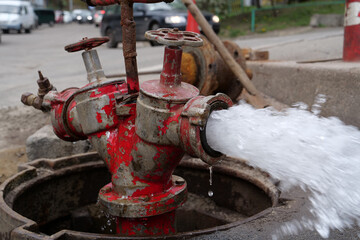 Water flows from faucet and pipe. Draining water from building plumbing system