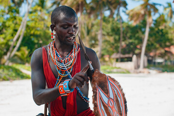 Maasai warrior on the beach Diani Beach, Kenya Mombasa - obrazy, fototapety, plakaty