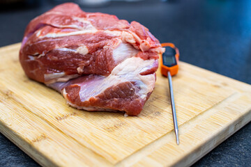 raw beef shoulder on a cutting board. Meat to be boiled in tradional italian dish 