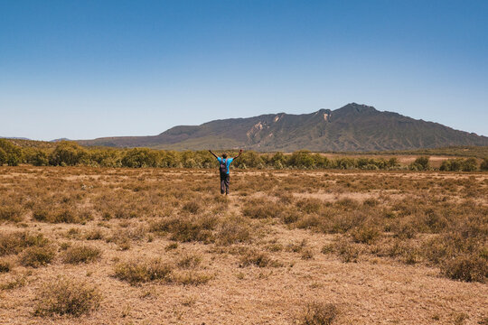 A hiker against the background of Mount Longonot in Naivasha, Kenya