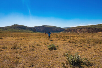 A hiker against  volcanic rock formations at Hell's Gate, Naivasha, Kenya