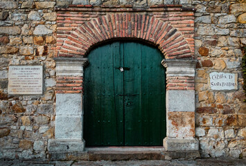 Fototapeta na wymiar old wooden arch door in a wall