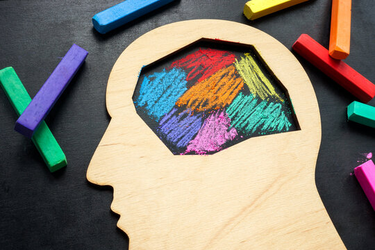 The head is painted with colored crayons. Neurodiversity or autism concept.
