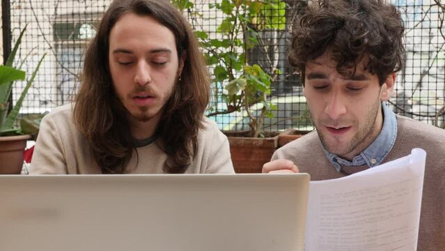work together - young men translating a text together on the computer