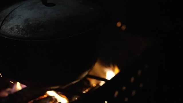 Soft focus on the grill with a cauldron on it