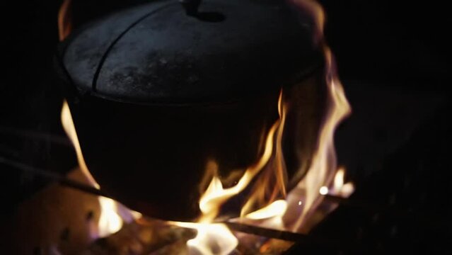 Cooking food on an open fire in a cauldron