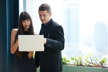 businesswoman and businessman working with laptop computer in the office