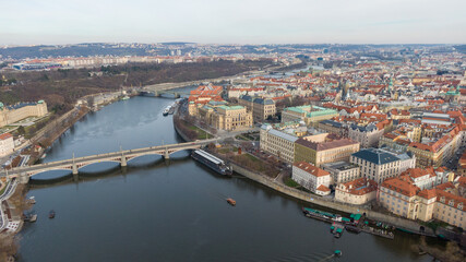 Obraz premium Aerial view of River and buildings in Old Town of Prague, Czech Republic. Drone photo high angle view of City