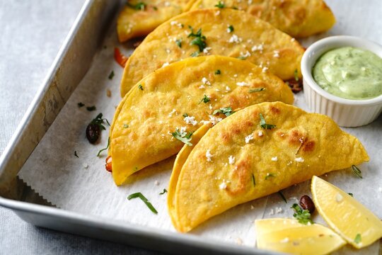 Crispy fried rice and beans tacos | Game day appetizer served with avacado cream sauce