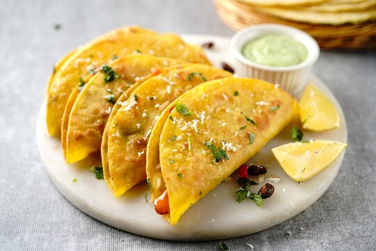 Crispy fried rice and beans tacos | Game day appetizer served with avacado cream sauce