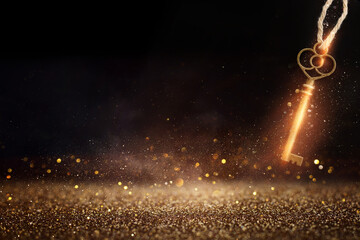 Golden key with glowing lights and dark background, wisdom, wealth, and spiritual concept - obrazy, fototapety, plakaty
