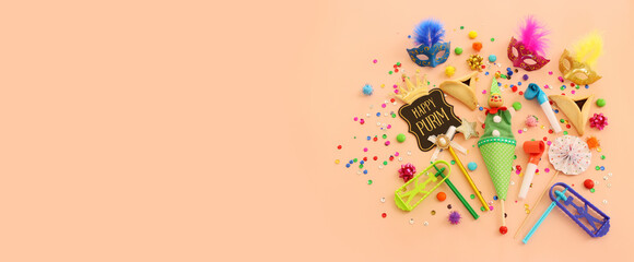 Purim celebration concept (jewish carnival holiday) over pastel background. Top view, flat lay