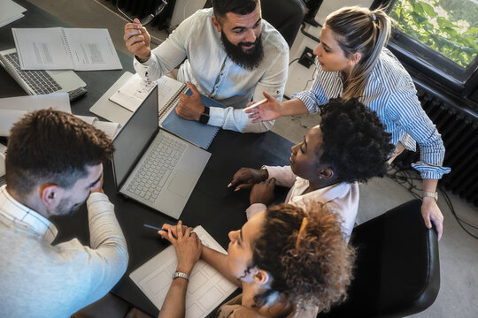 Day in the business office. Group of programmers discussing ideas at the office for a new startup project.	
