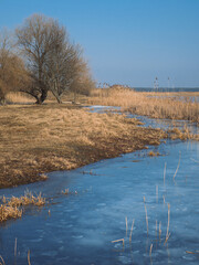 frozen lake winter landscape near the lake covered with ice. frosty weather on a walk by the river in winter.
