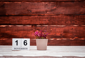 November calendar with number  16. Planner copy space on a wooden brown background. March number...