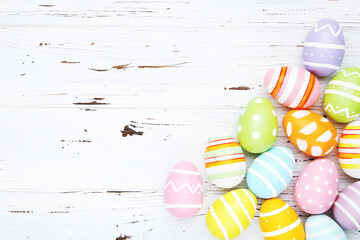 Colorful eggs on white wooden background