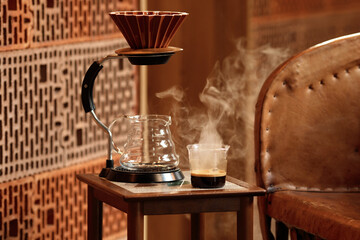 Glass of espresso on coffee table