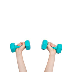 Two hands hold blue dumbbells weighing 1 kilogram each. Sport at home concept. Hand and dumbbells...