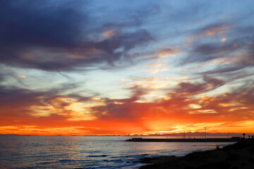 Sunset sky clouds over the sea in Apulia, Italy. Beautiful sunlight in the sea. Amazing nature landscape seascape Colorful sky clouds background.