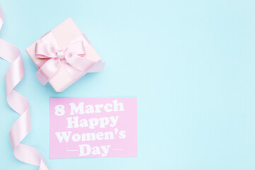 Card with text 8 March Happy Women's Day, ribbon and gift box on blue background