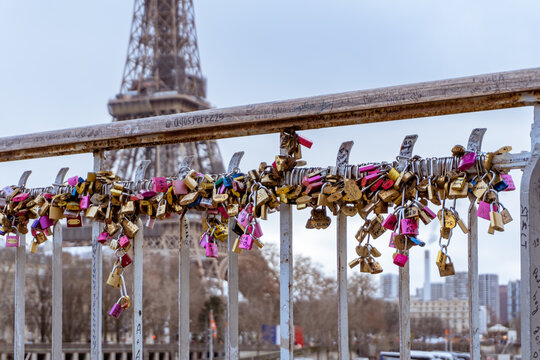 Love locks line the railings of the Debilly Footbridge, a pedestrian bridge crossing the Seine river near the Eiffel Tower.