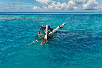 Aerial view of a sunken ship near Keyodhoo, Vaavu Atoll, Maldives, Indian Ocean. A place for...
