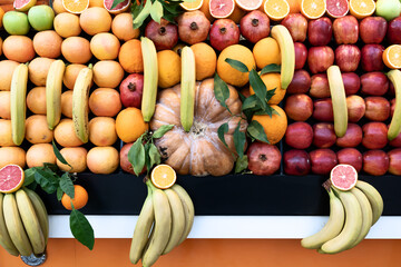 Lots of different fruits. Various fruits oranges bananas apples, the whole surface is covered with citrus fruits. Fruit background. Healthy food.