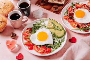 Couple breakfast on Valentines Day on pink background, top view