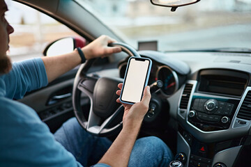 Screen blank mockup mobile phone in the hands of a man driver in a car