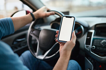 Close up Screen blank mockup mobile phone in the hands of unrecognizable man driver in a car
