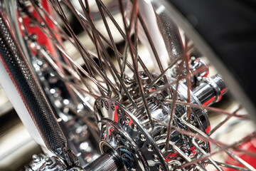 Close up of the metal alloy wheel of a custom motorcycle. very clear detail of the spokes of a motorbike.