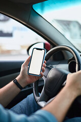 Close up Hands of unrecognizable man driver using white screen mockup mobile phone while driving