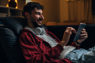 Caucasian man is using hid tablet in the evening