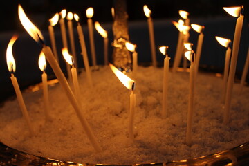 burning candles in the church, flowers, birds.