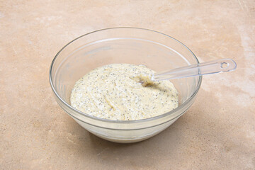 Lemon clip with poppy seeds on a beige background