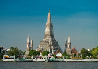 Morning at Wat Arun temple. View of the magnificent temple from the other side of the river. It is one of Thailand's most important travel destinations.