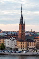Fototapeta premium Stockholm, Sweden - July 18th 2022: A view of the Riddarholmen Church of Stockholm's old town from above.