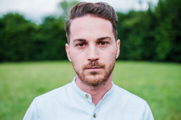 Fototapeta premium close-up of a young man with a serious and grim face. Concept: Lifestyle, pissed off, seriousness