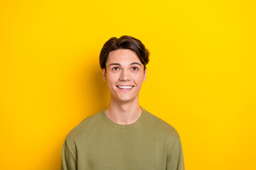 Photo of minded creative man beaming smile look interested up empty space isolated on yellow color background