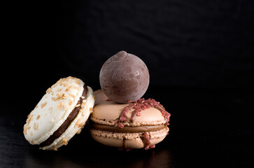 Close-up of Delicious Macarons with Chocolate Ball on Dark Background