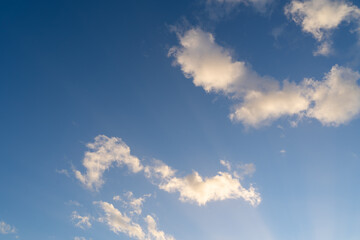 Blue sunny sky with white clouds on a spring evening