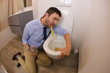Man vomiting while holding alcoholic drink  - obrazy, fototapety, plakaty