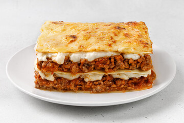 Homemade Italian lasagna. Delicious Lasagne with bolognese meat sauce on white plate. Hot Tasty Lasagna with Cheese for Menu, recipe.