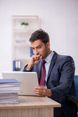 Naklejka premium Young male employee working in the office